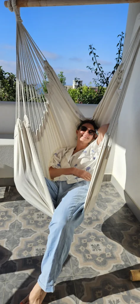 Person relaxing in a white hammok