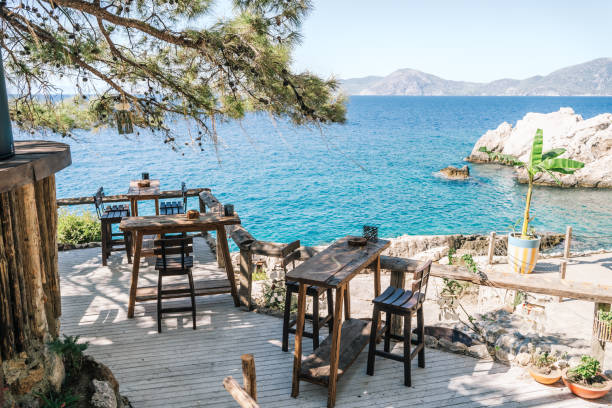 Wooden table in an outdoor cafe on the blue sea background.